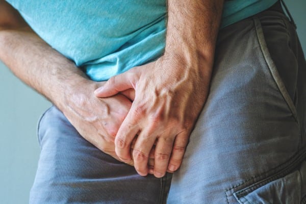 Urinary tract infection concept, man with painful medical condition, selective focus