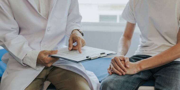 Male health concepts. The young man with pain consulted a doctor for treatment. The doctor is interviewing and advising the patients.